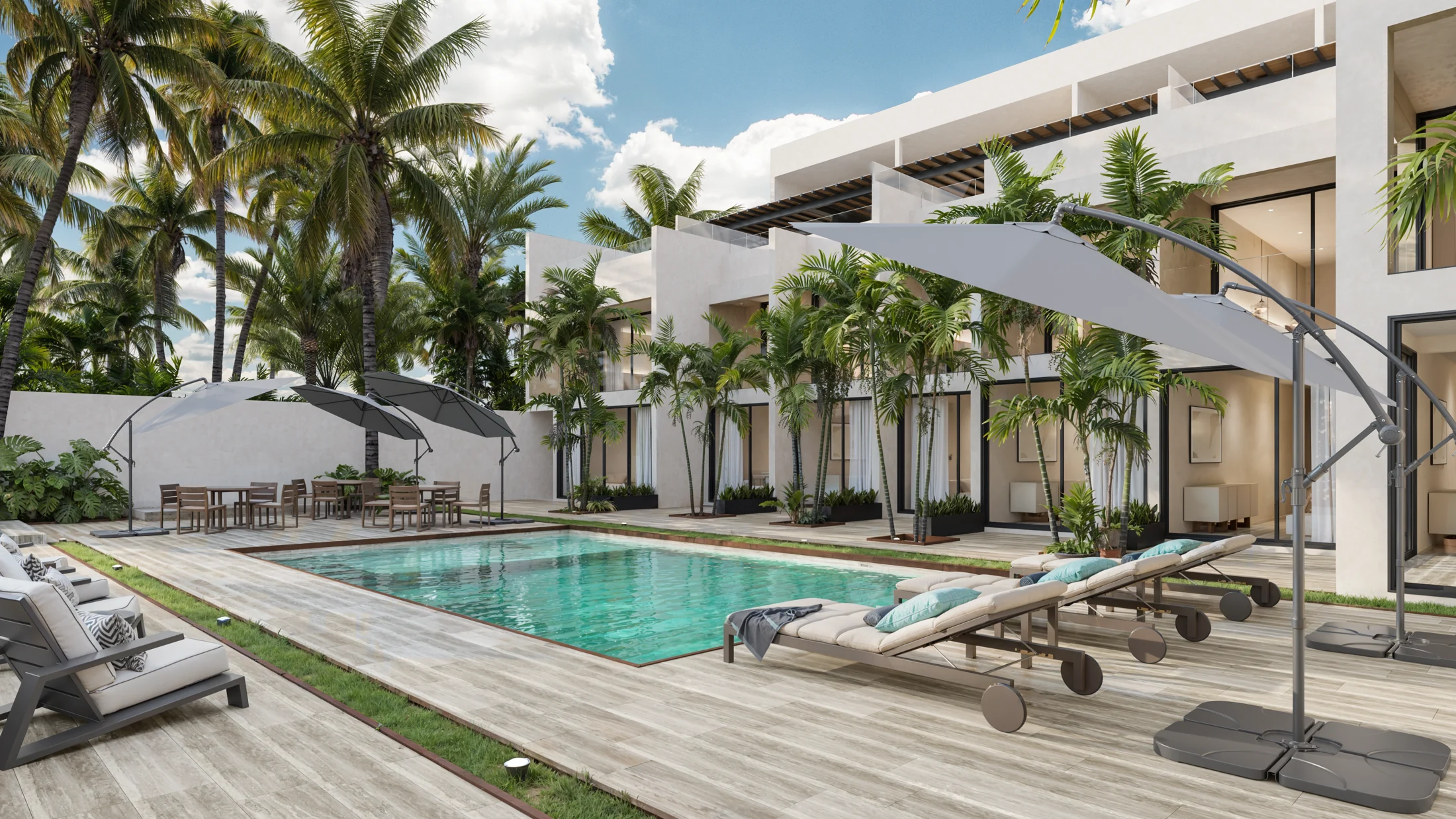 Outdoor pool with lounge chairs, umbrellas, and tropical landscaping