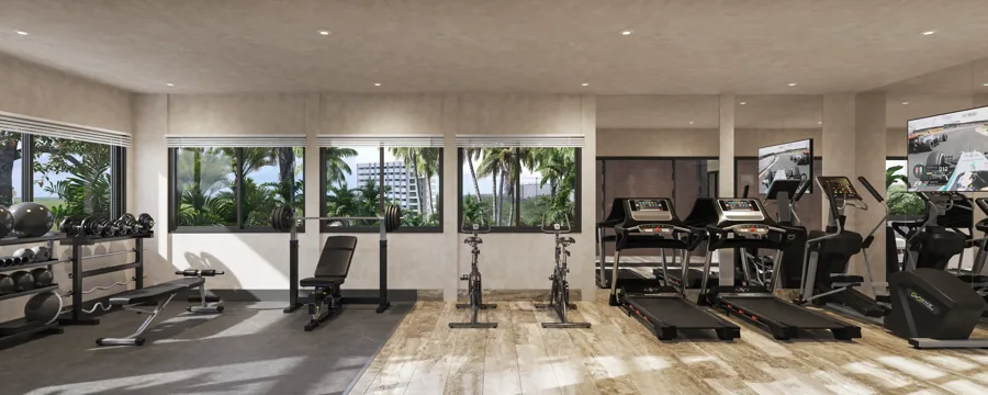Fitness center with large windows overlooking tropical landscaping